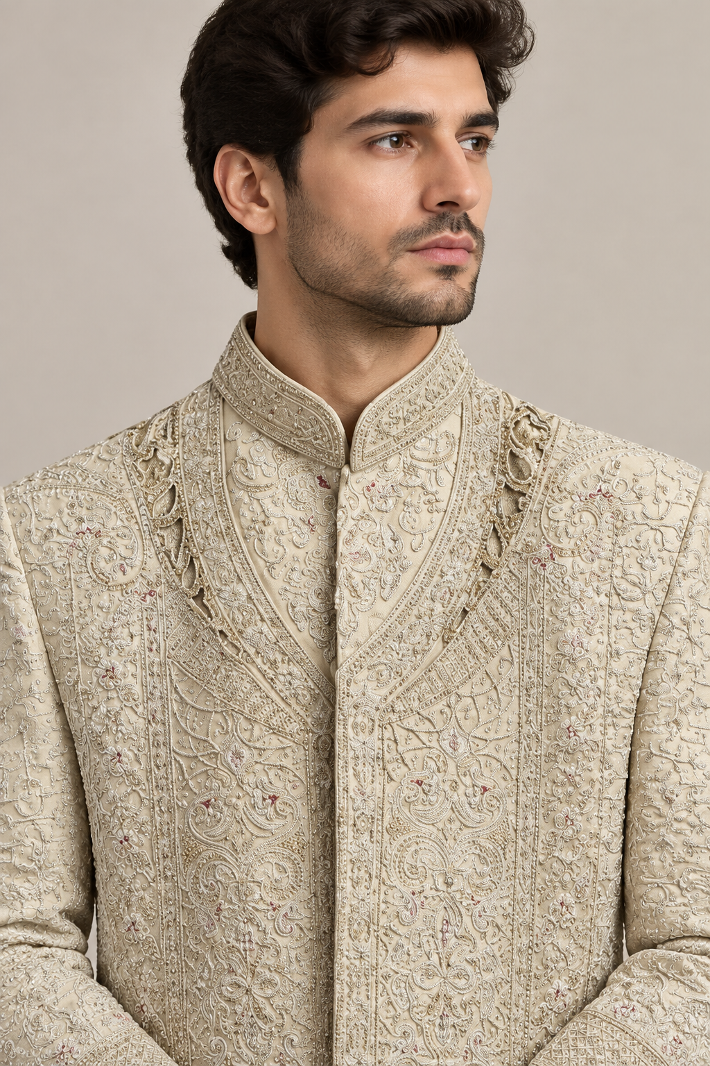 Close-up of ivory sherwani's patterned standing collar and neckline