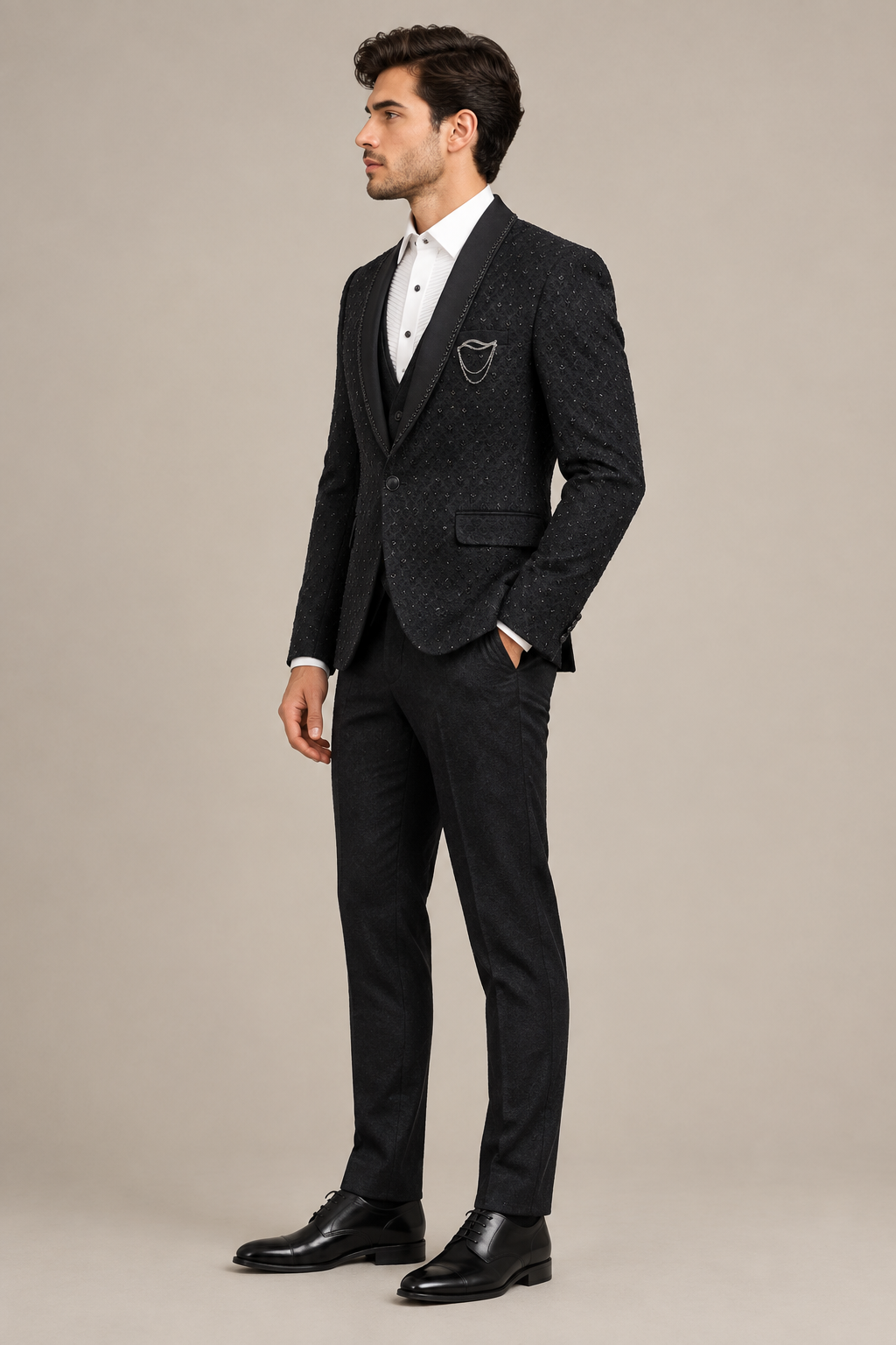 Side view of model wearing dark patterned formal jacket, white shirt, dark trousers and black dress shoes