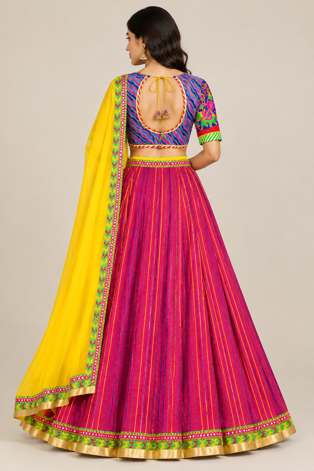 Model from behind in magenta striped lehenga and open-back patterned choli