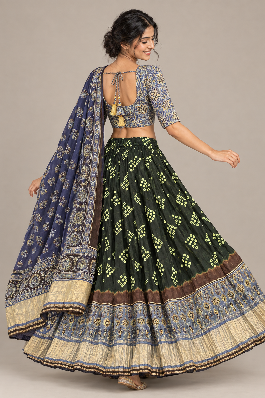 Rear three-quarter view showing blouse tie-back, green lehenga and navy dupatta