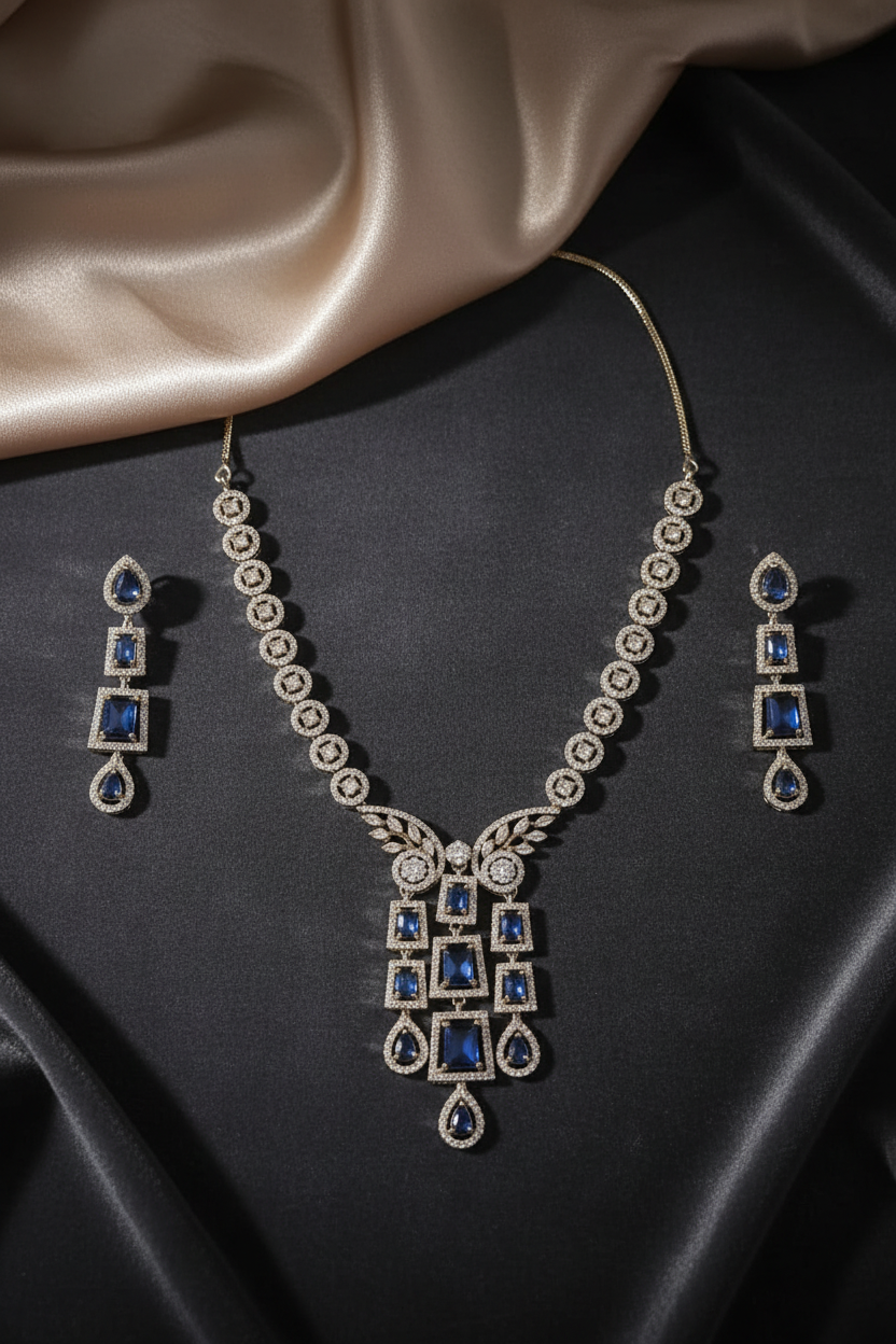 Silver-tone blue stone necklace set with matching earrings on dark velvet