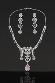 Shreya silver-tone necklace set with pale pink stones and matching chandelier earrings on a reflective dark surface