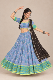 Model in blue garba chaniya choli with matching light-blue blouse and black mirror dupatta, front view