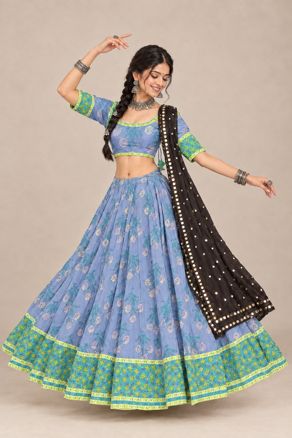 Model in blue garba chaniya choli with matching light-blue blouse and black mirror dupatta, front view