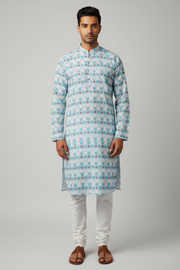 Male model wearing teal geometric print kurta set with kolhapuri sandals - front pose