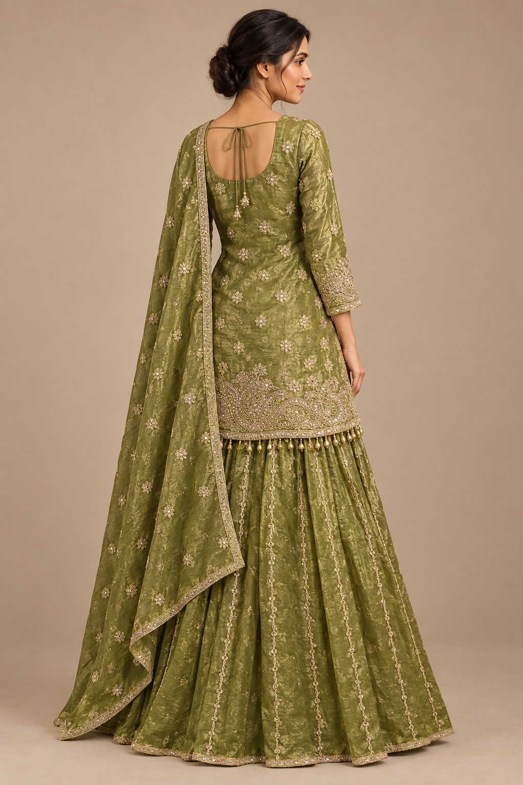 Rear three-quarter view of olive lehenga showing rounded blouse back and tie cords