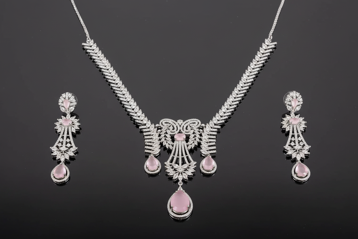 Shreya silver-tone necklace and matching chandelier earrings arranged on a dark reflective surface