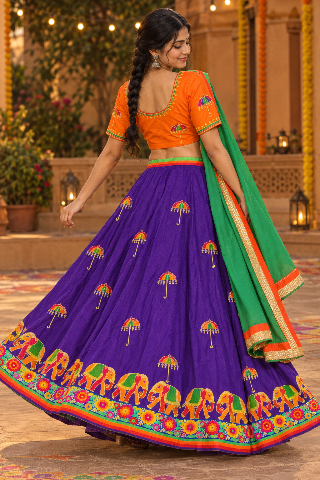 Model wearing the purple umbrella-motif Garba lehenga set with orange choli and green dupatta, rear three-quarter view