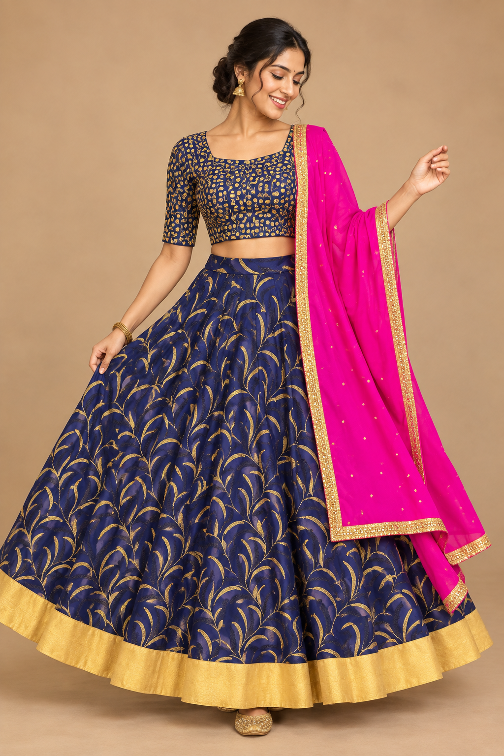 Front three-quarter view of model in navy gold-patterned lehenga, navy blouse and pink dupatta