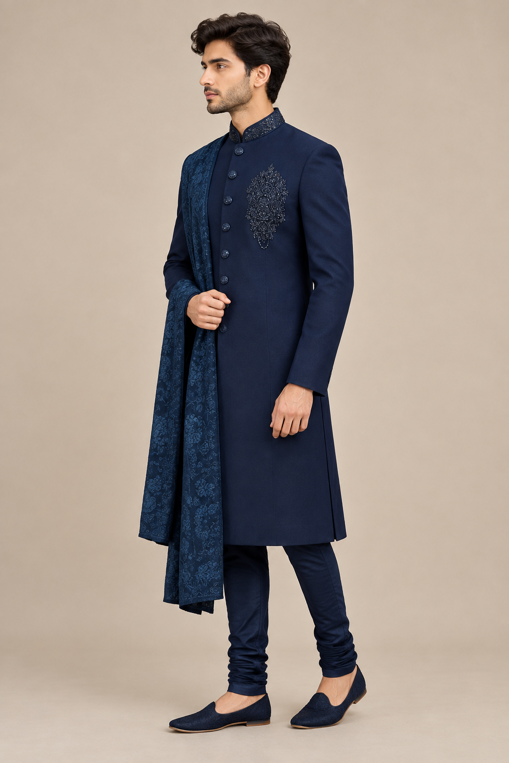 Side profile view of model wearing navy beaded-collar sherwani set with matching churidar and dupatta