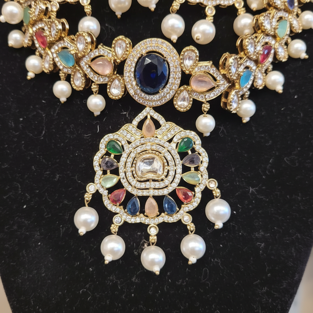 Close detail of the necklace center with a large blue stone, clear crystal-style detailing, multicolor accents, and pearl-like drops.