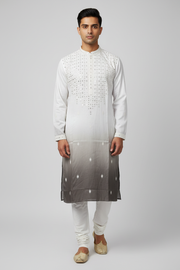 Male model wearing white ombre sequin kurta set with gold juttis - front pose