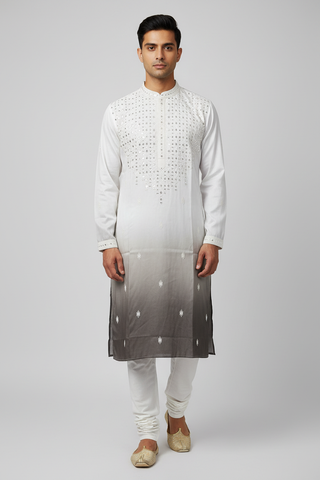 Male model wearing white ombre sequin kurta set with gold juttis - front pose