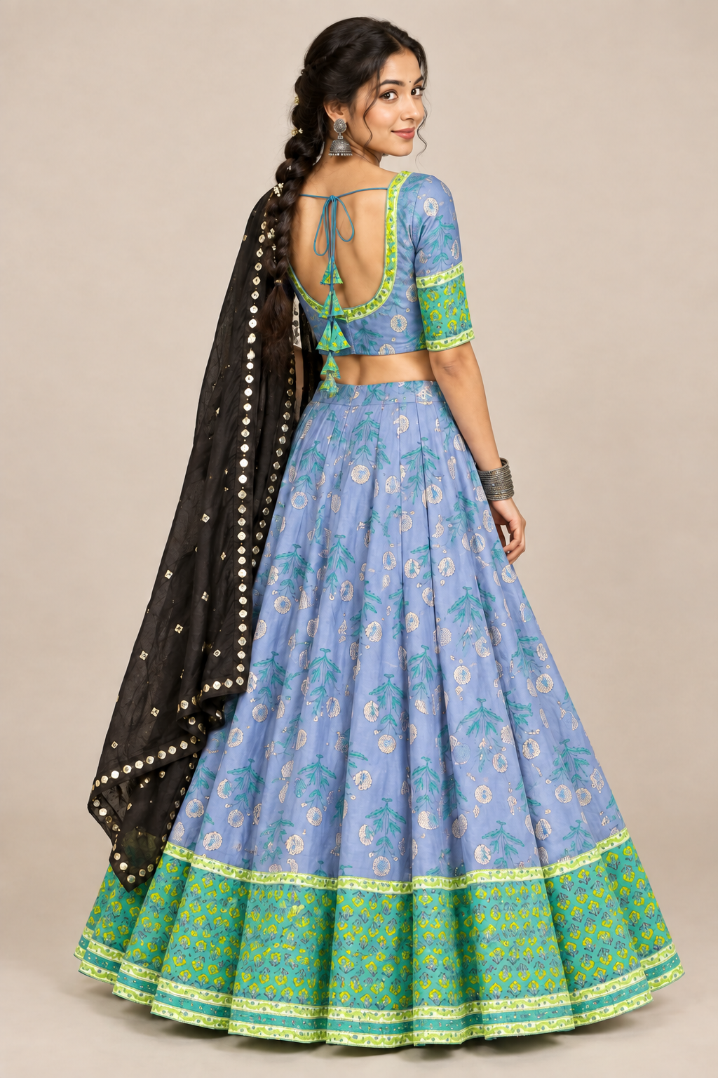 Back view of matching light-blue tie-back choli with blue chaniya and black mirror dupatta