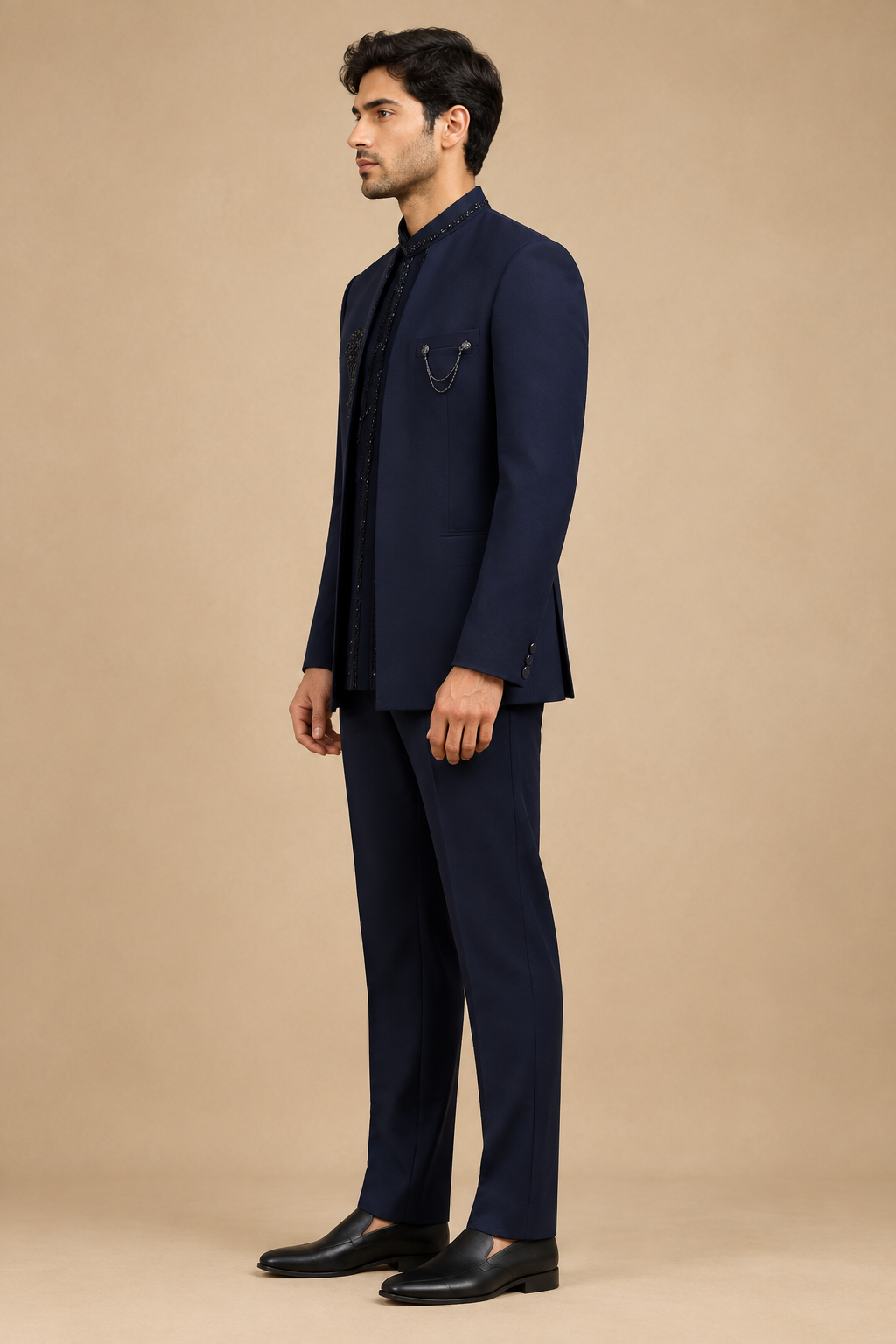 Side view of male model wearing dark navy stand-collar bandhgala outfit and matching trousers