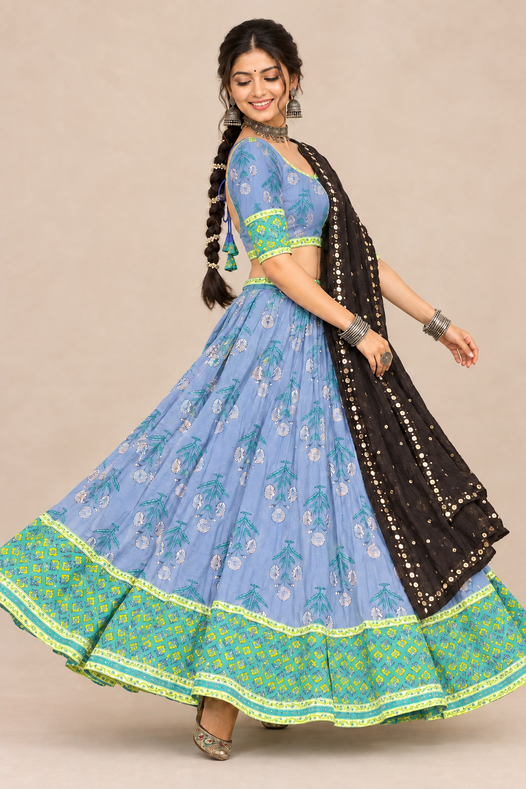 Model twirling in blue printed chaniya choli with matching blouse, side view