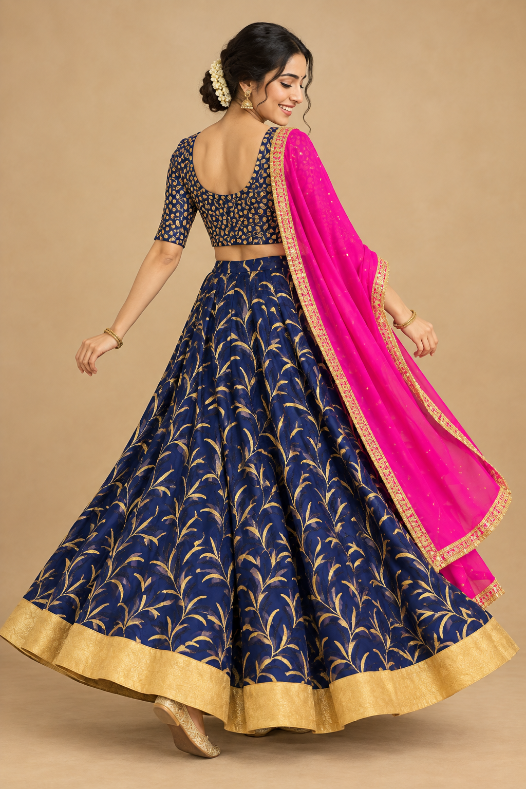 Rear three-quarter view of navy patterned lehenga and pink dupatta
