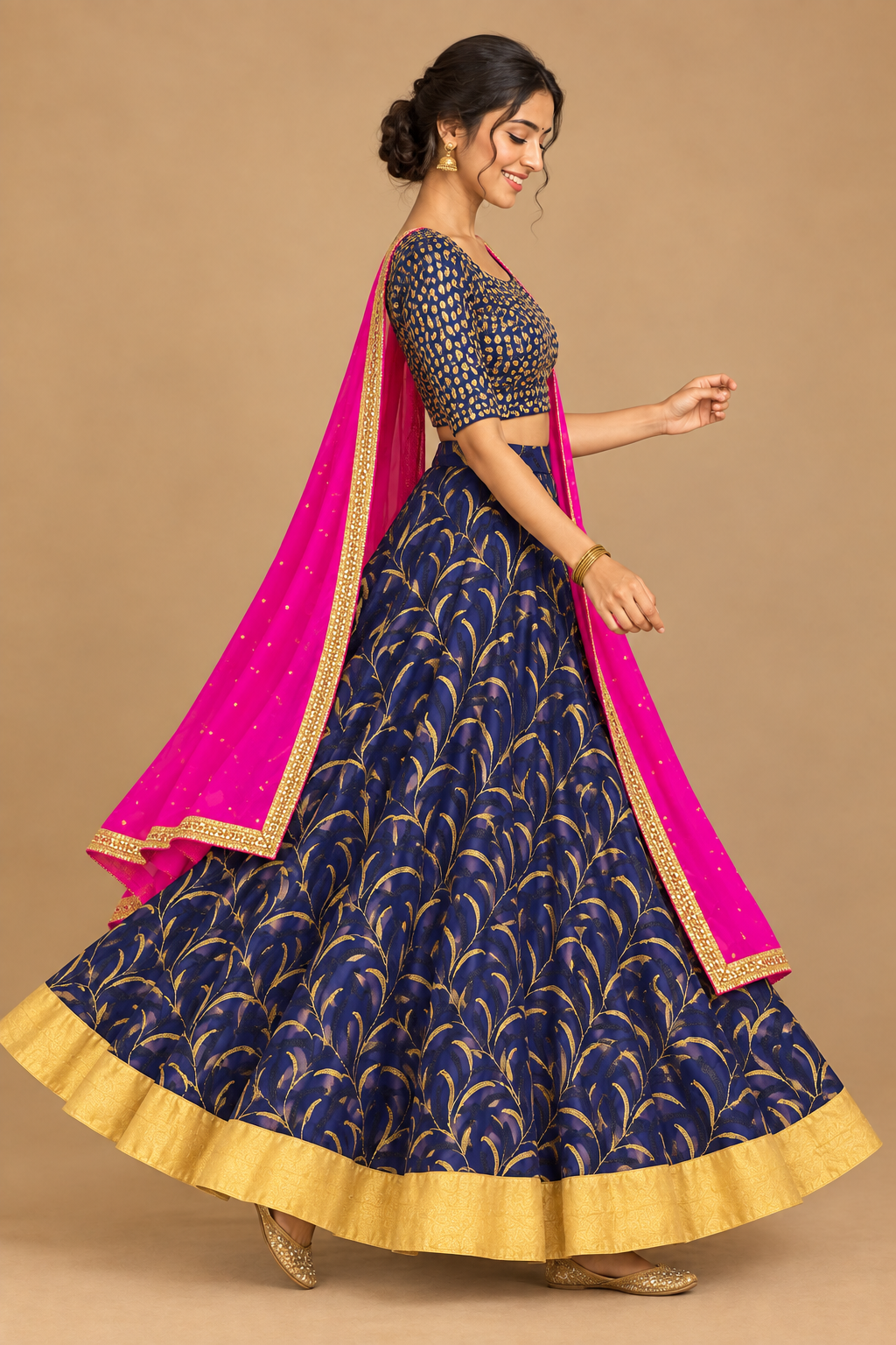 Side view of model in navy gold-patterned lehenga and pink dupatta